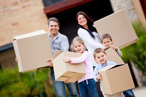 Professional movers handling furniture during a house move in Becontree